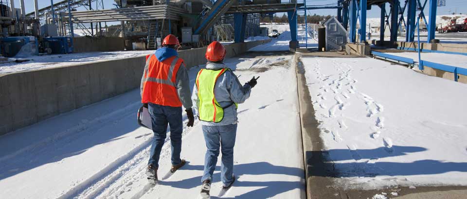 two workers walking outside in the snow