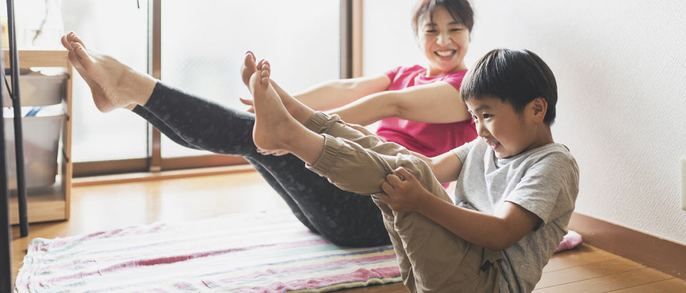 a mother and son doing yoga inside together