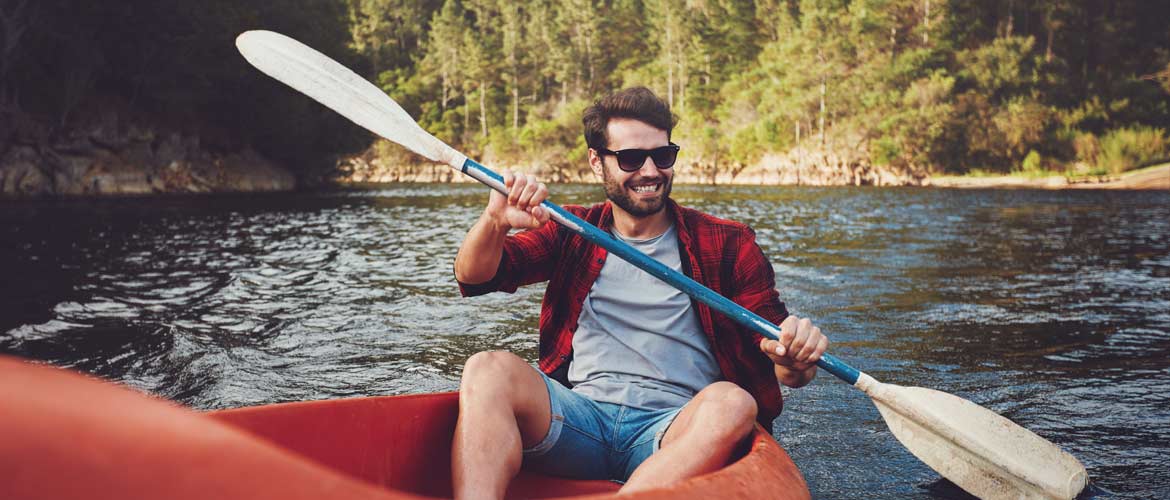 man wearing sunglasses while canoeing
