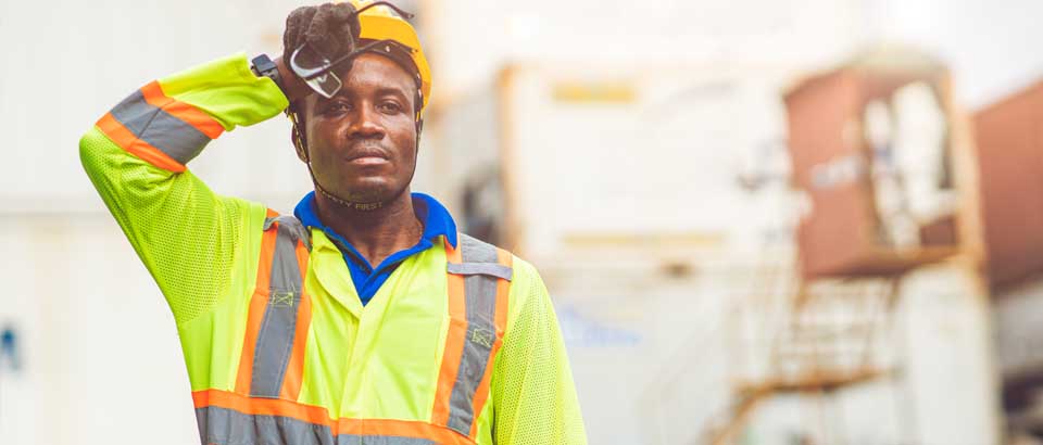 working man wiping sweat from brow