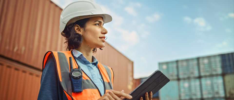 women in hard hat working on tablet