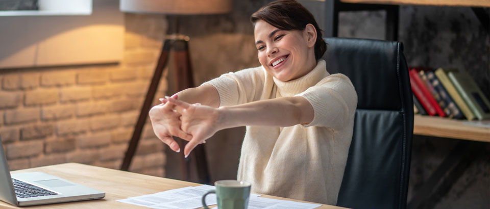 woman with intertwined fingers stretching