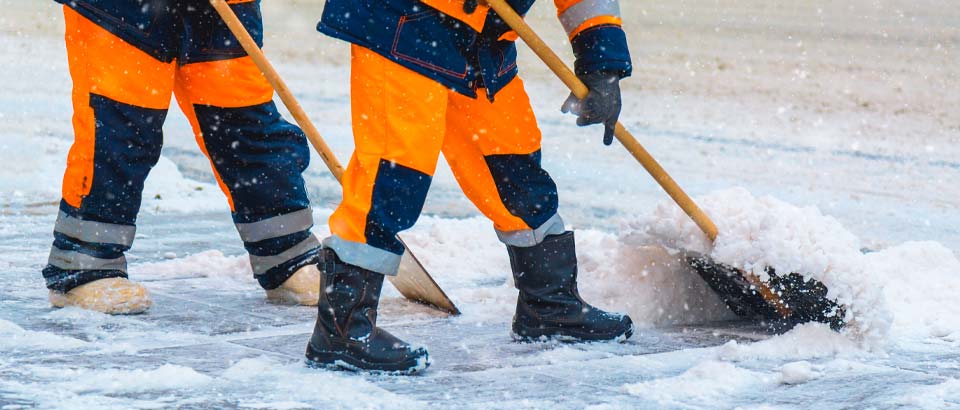 two people shoveling snow