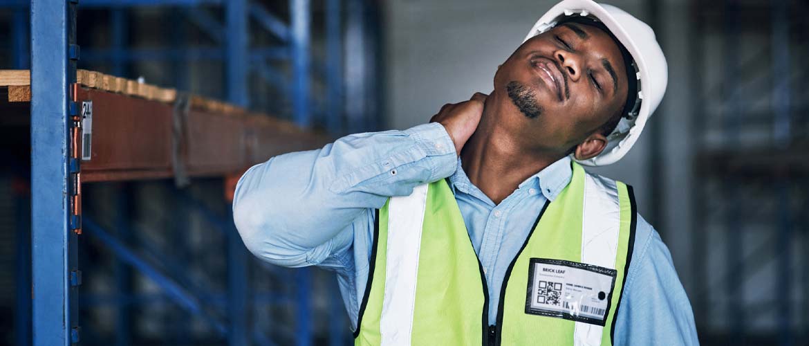 man with hard hat rubbing neck