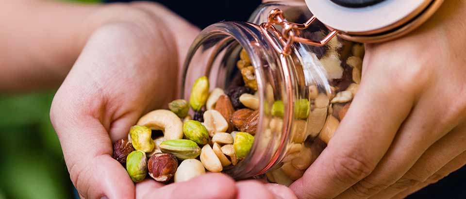 pouring mixed nuts into hand