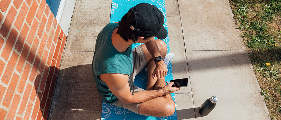 a man sitting on a yoga mat