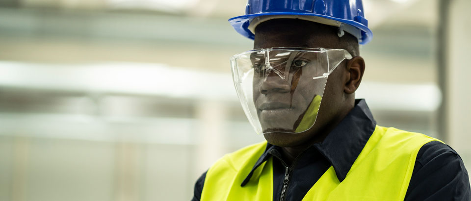 construction worker wearing a hard hat and face shield