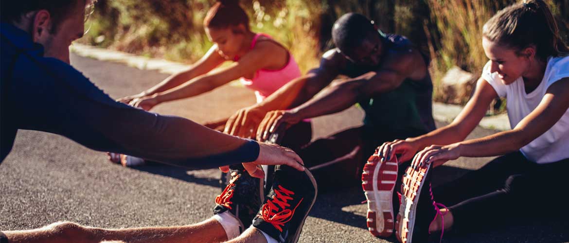 man and woman stretching before exercise