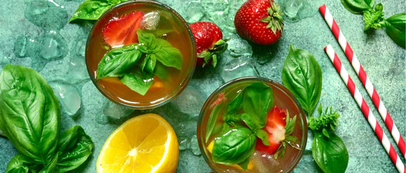 glass of strawberry , lemon and basil water