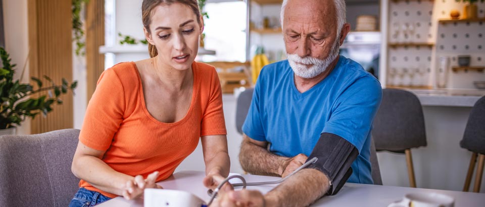 two adults measuring their blood pressure