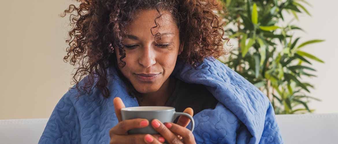 woman holding a cup of hot tea