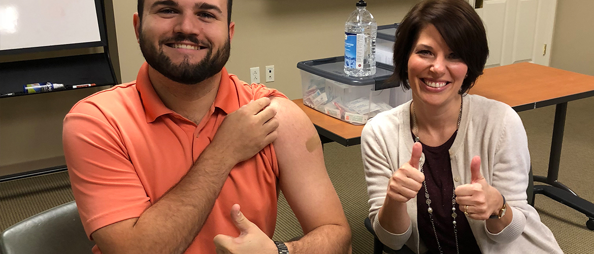man and nurse with thumbs up after flu shot