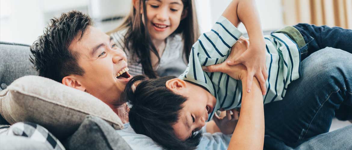 dad playing with two young children