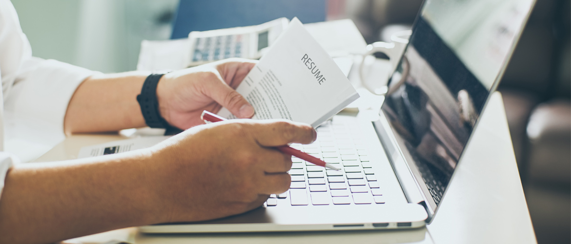 person proofreading a resume at their computer