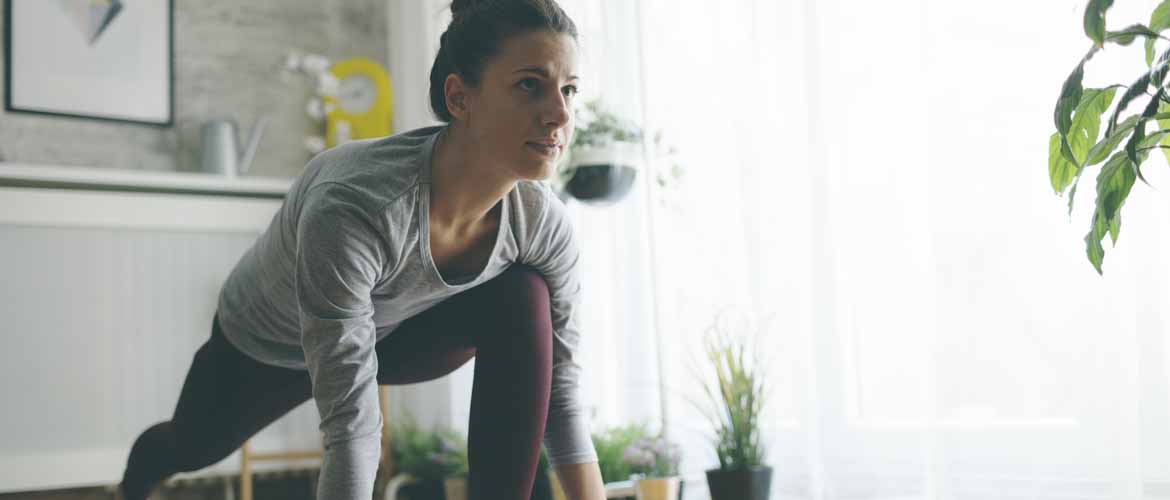 a woman practicing yoga in her living room