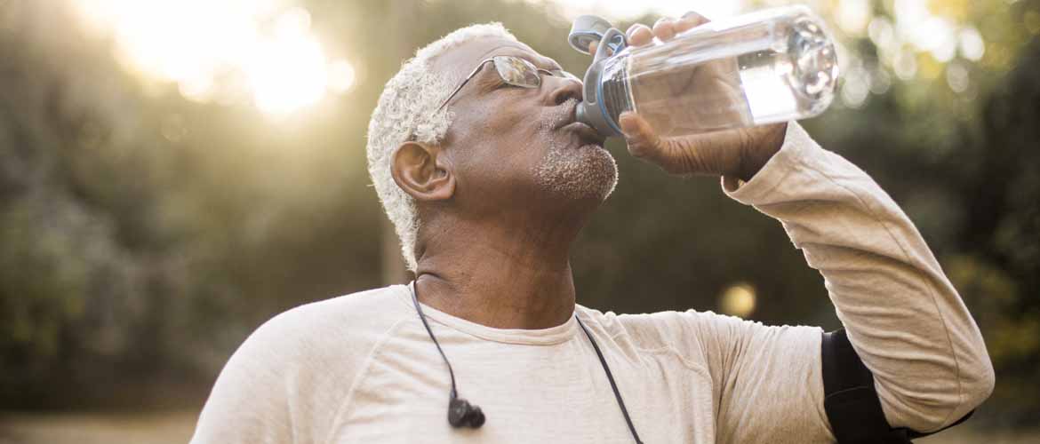 an older man drinking a bottle of water