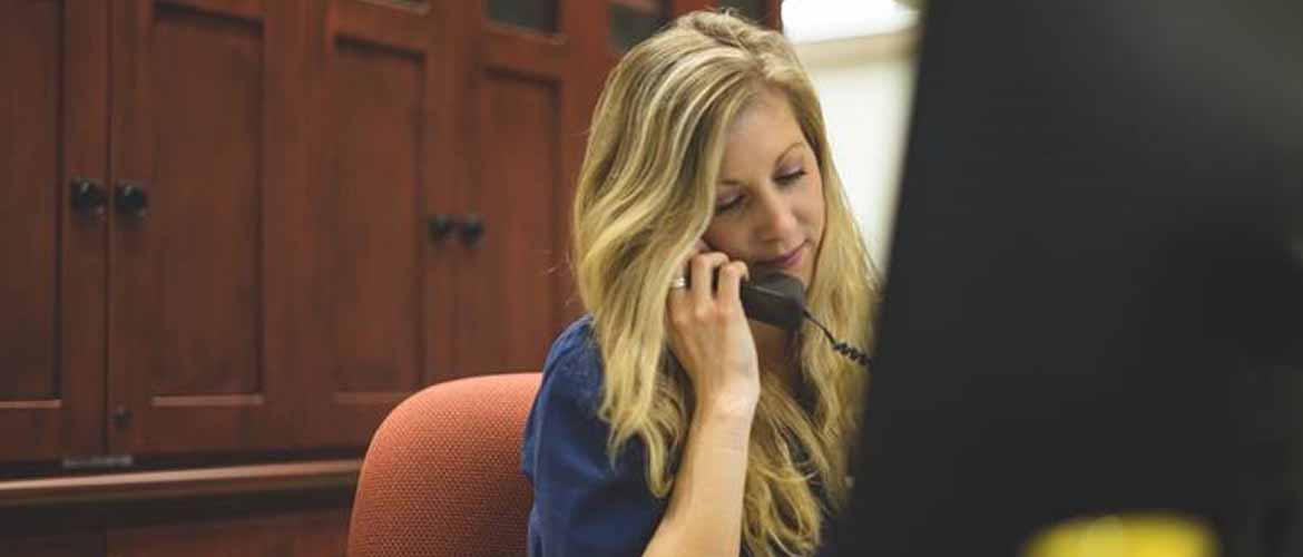 Jessica Speer answering a phone call at a MedExpress center