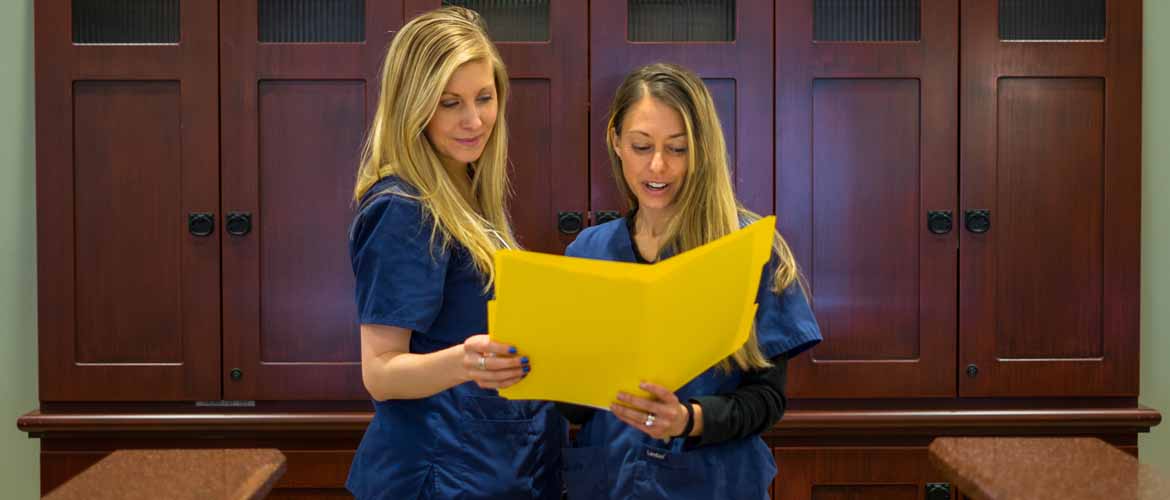 Jessica Speer reviewing documents with Doctor Rebekah Marquis