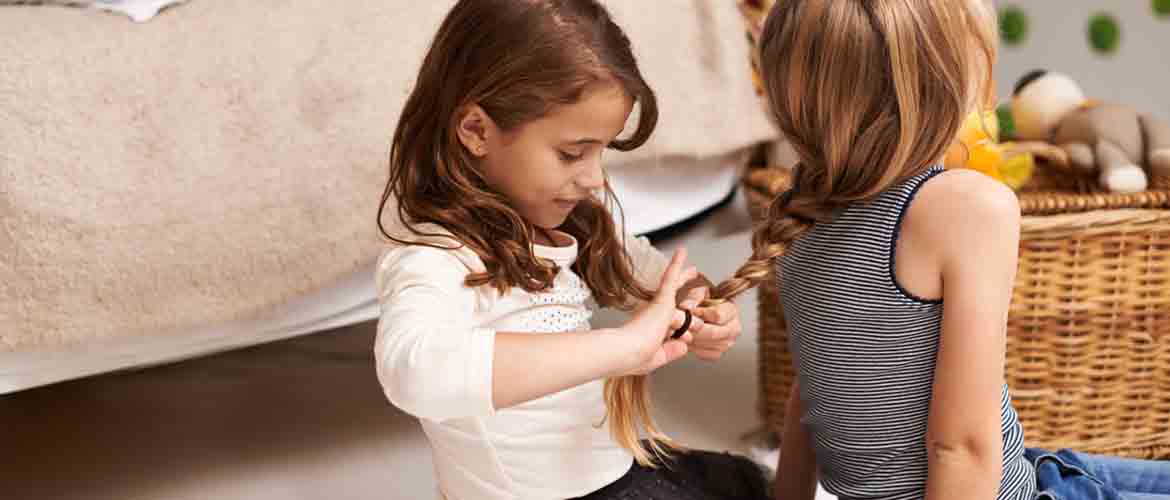 Child creating a ponytail