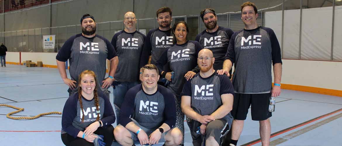 a group of MedExpress Administrative Office employees at an annual charity event