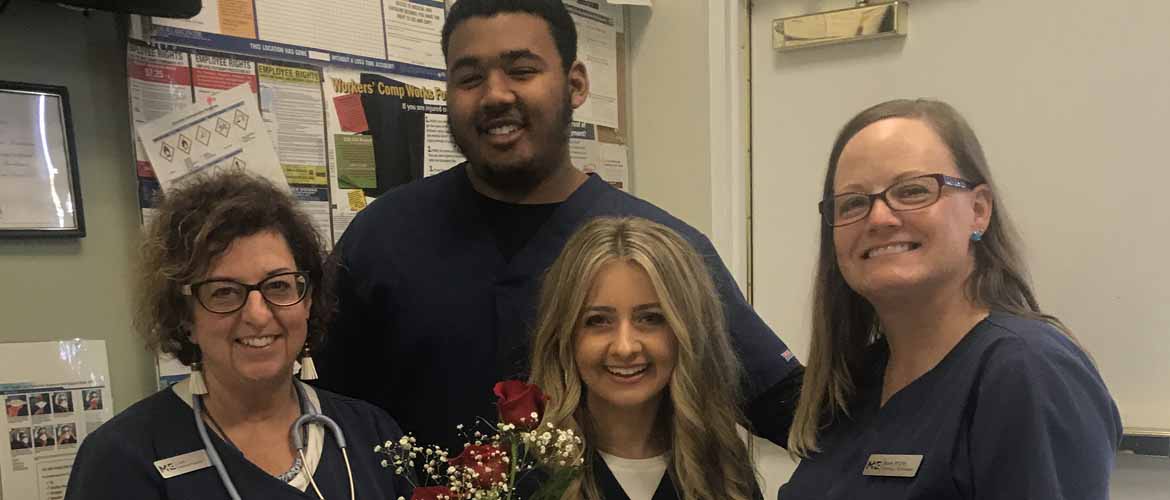 four MedExpress center employees standing and smiling