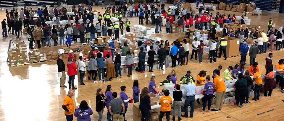 dozens of volunteers putting together care packages at Operation Gratitude's event in Washington D.C.
