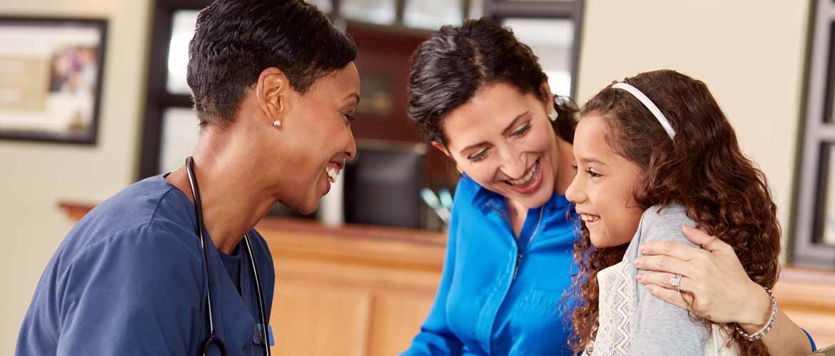 MedExpress employee talking to a parent and child