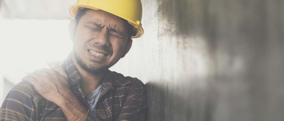 man holding his should in pain