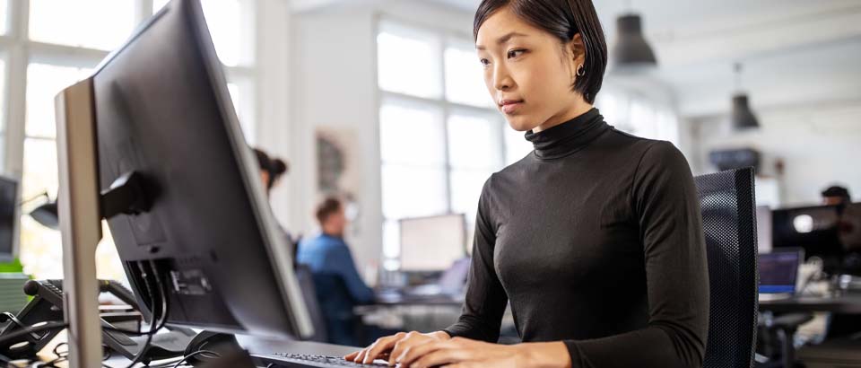 women sitting up straight working on computer