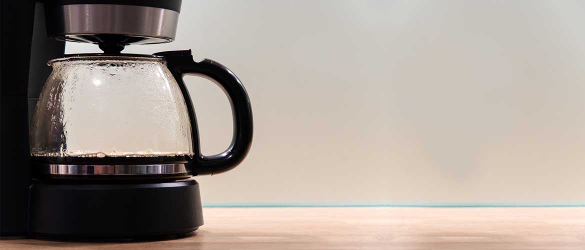 A coffee pot with small amount of coffee in it