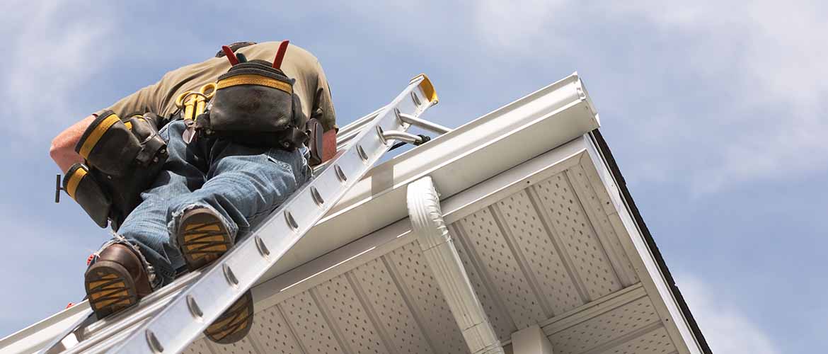 a construction worker climbing a ladder