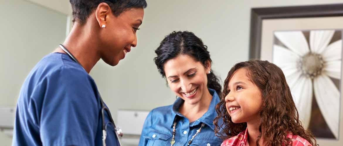a MedExpress clinical staff member interacting with a mother and her daughter