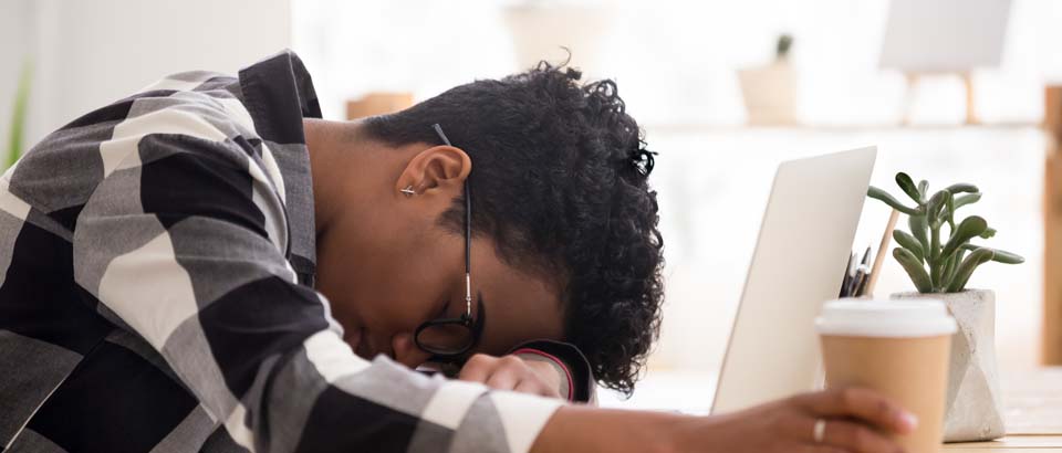 man stressed and laying head down