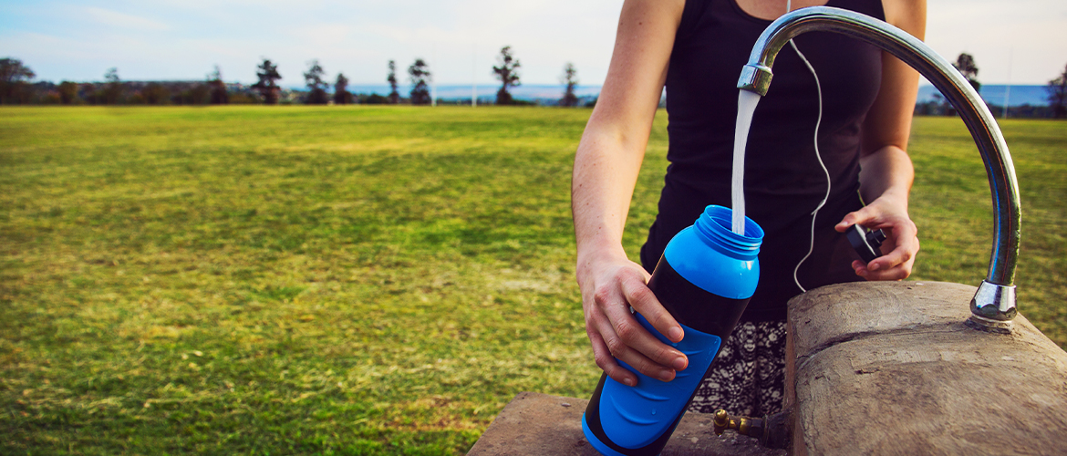 woman filling a water bottle