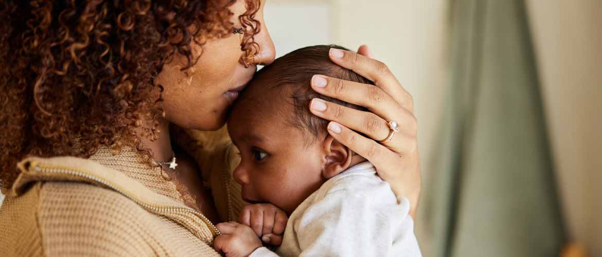 a mother holding her newborn baby